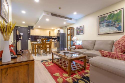 a living room with a couch and a table at Citismart Residence in Pattaya