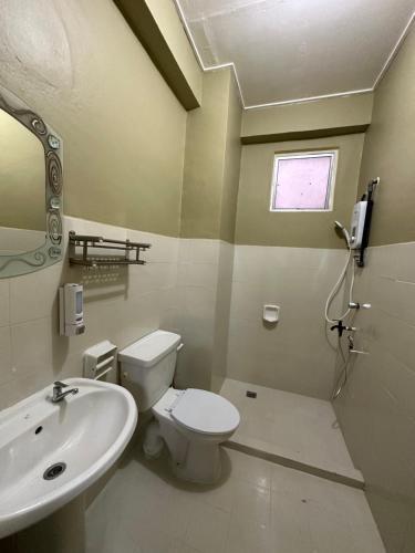 a bathroom with a toilet and a sink at Family apartment in Tawau city centre in Tawau