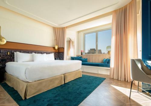 a bedroom with a large bed and a large window at Only YOU Hotel Valencia in Valencia