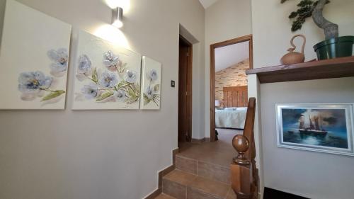 a hallway with four pictures on the wall at Casa NeGo in Calpe