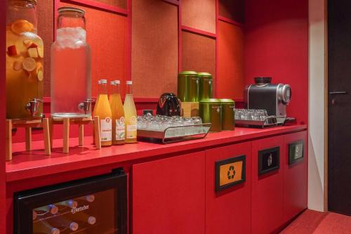 a red counter with drinks and bottles on it at Novotel Paris Gare De Lyon in Paris