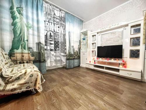 a living room with the statue of liberty on the wall at Квартира in Ustʼ-Kamenogorsk