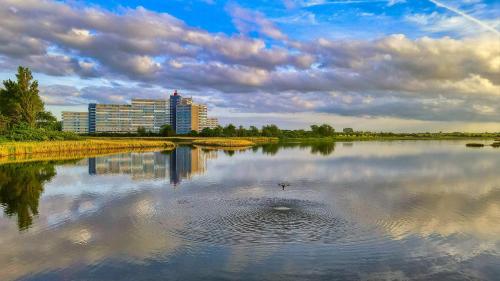 a body of water with a building in the background at Ferienpark A05-008 Ferienpark in Heiligenhafen