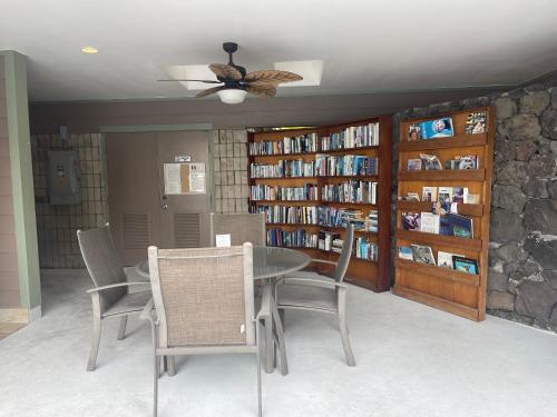 a dining room with a table and chairs in a library at Alii Villas Condominiums in Kailua-Kona