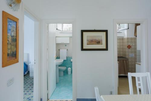 a bathroom with a sink and a toilet in a room at Capri holiday home with a sea view in Capri