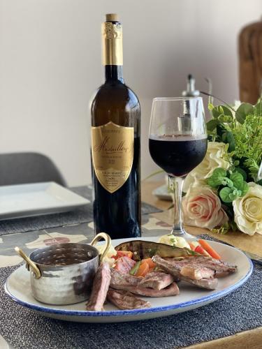 a plate of food and a bottle of wine and a glass at Bavaro Beach Dakhla in Dakhla