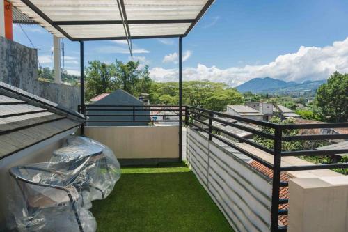 a balcony with a view of the mountains at Amarillo Lembang in Lembang