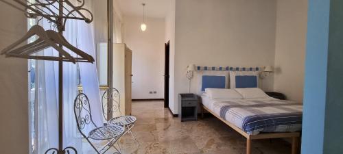 a bedroom with a bed and two chairs in it at Stay Bergamo in Bergamo