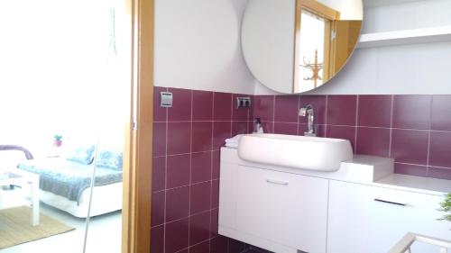 a bathroom with a sink and a mirror at Lovely Cat's B&B in Urrúnaga