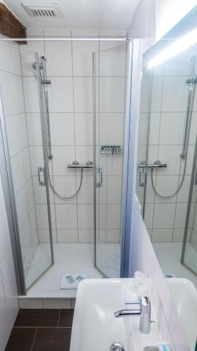 a bathroom with a shower and a sink at Hotel Brauhaus Wiesenmühle in Fulda