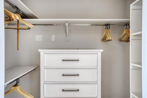 a white closet with a white dresser and shelves at Redwood City 2BR w AC Gym WD nr Caltrain SFO-1110 in Redwood City