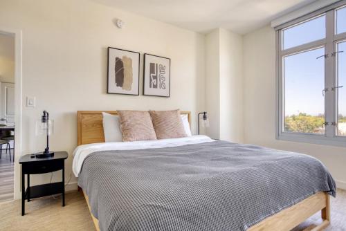 a white bedroom with a bed and a window at Mountain View 2BR w Gym Lounge nr Highways SFO-1080 in Los Altos