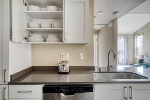 a kitchen with a sink and white cabinets at San Jose - The Alameda 2br w gym pool SFO-1153 in San Jose