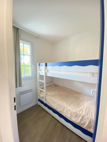 une chambre avec deux lits superposés et une fenêtre dans l'établissement Joli appartement tout confort près de la plage, à Fouesnant