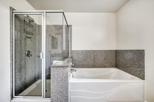 a white bath tub in a bathroom with a shower at San Mateo 2br w gym pool clubhouse wd nr 101 SFO-1249 in San Mateo