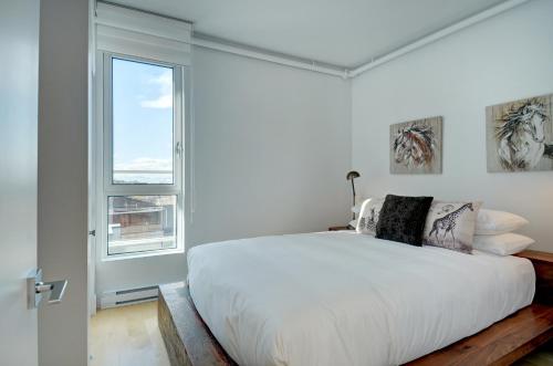 Ένα ή περισσότερα κρεβάτια σε δωμάτιο στο Les Immeubles Charlevoix - Le 760-705