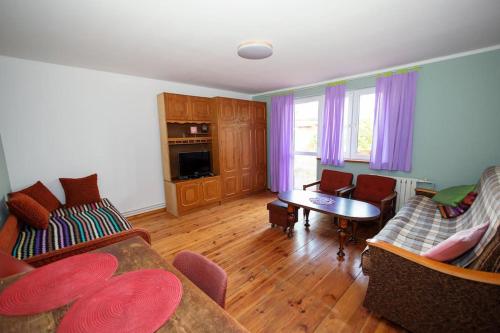 a living room with two couches and a table at Free Bikes, WiFi, AC, Garden, 2 Beds in Duczki