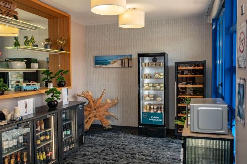 a room with an open refrigerator in a store at Best Western Arcachon Le Port in Arcachon