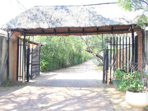 an entrance to a building with a metal gate at Atlantic Pearl Guest House Midrand in Midrand