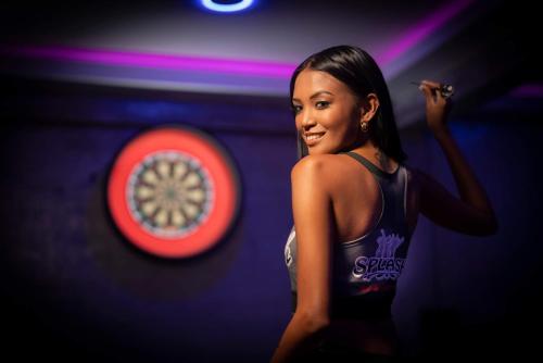 a woman standing in front of a red frisbee at Splash Bar and Guesthouse in Pattaya Central