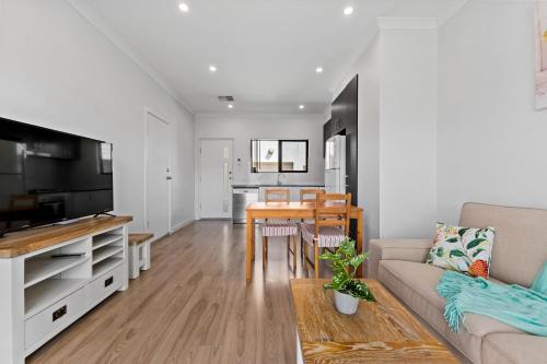 a living room with a couch and a table at Swainson on Bernards in Campbelltown