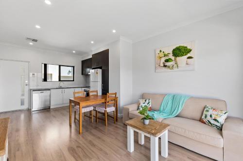 a living room with a couch and a table at Swainson on Bernards in Campbelltown