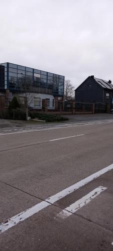 an empty street with a building in the background at Wenceslas Cobergher II Appartementen 2 of 4 in Boutersem