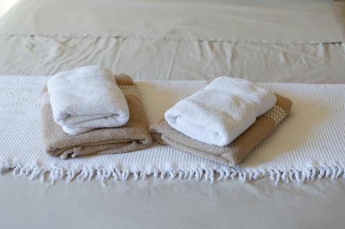 two towels are sitting on top of a bed at Villa Serenity B&B in Sannat
