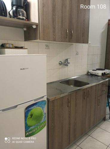 a kitchen with a refrigerator and a sink at Rooms Anastasia Paralia in Paralia Katerinis