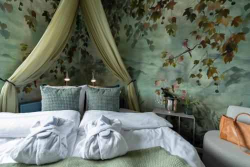 a bedroom with two beds with towels on them at Villa Lovik in Lidingö