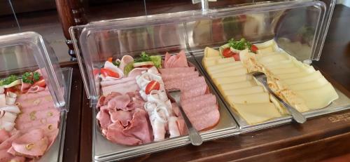 a display case with different types of meats and cheese at Spa Hotel Purkyně in Karlovy Vary