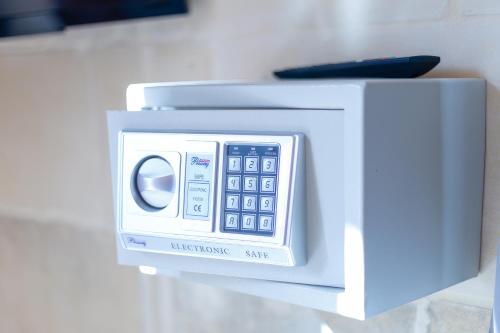 a white microwave sitting on top of a counter at Villa Serenity B&B in Sannat