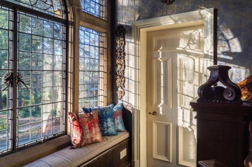 a window seat in a room with pillows on it at Fischers Baslow Hall - Chatsworth in Baslow