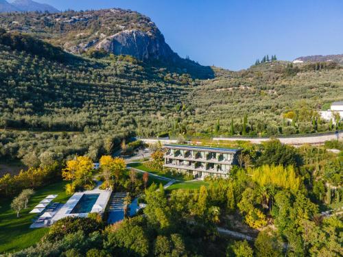 an aerial view of a building in the mountains at ARCOLIVE Agrisuite in Arco