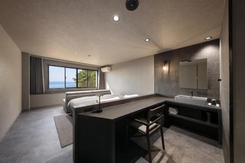 a bathroom with a sink and a bed in a room at TheMana Village in Tosashimizu