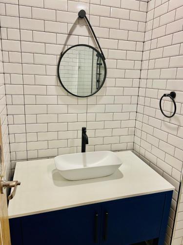 a bathroom with a white sink and a mirror at Bann Chidtha family suite full kitchen near Suvarnabhumi Airport in Bangkok