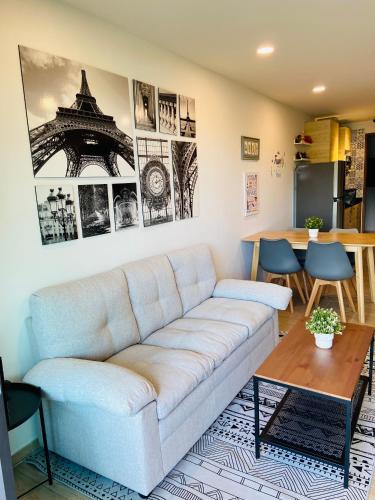 a living room with a couch and a table at Bann Chidtha family suite full kitchen near Suvarnabhumi Airport in Bangkok