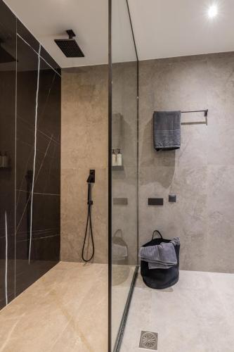 a bathroom with a shower with a glass door at Otium Residence in Kouvaláta