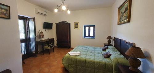 a bedroom with a bed and a desk in it at La Cicogna in Agerola