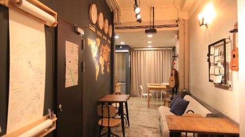 a living room with a couch and a table at DONGMEN 3 Hostel in Taipei
