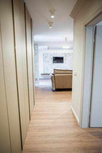 a hallway leading to a living room with a couch at Opera Apartments in Cluj-Napoca