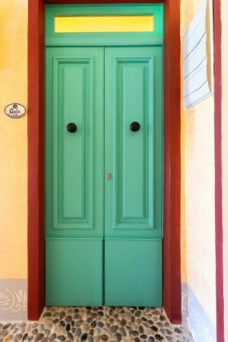 a green door on the side of a building at Villa Serenity B&B in Sannat