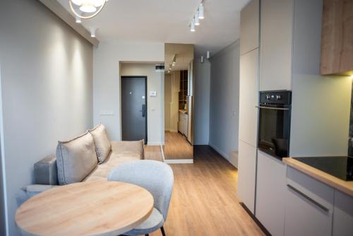 a living room with a couch and a wooden table at Opera Apartments in Cluj-Napoca