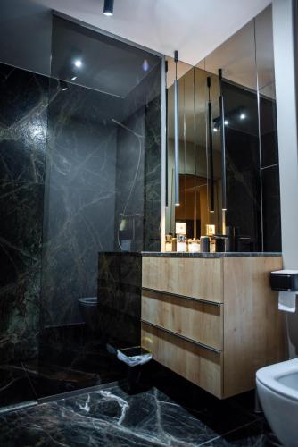 a bathroom with a sink and a mirror at Opera Apartments in Cluj-Napoca