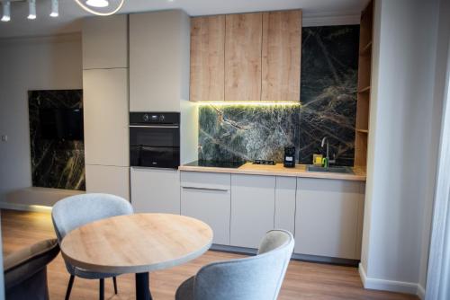 a kitchen with a table and chairs in a room at Opera Apartments in Cluj-Napoca