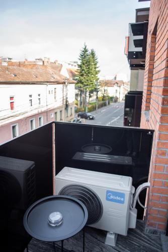 a computer on the back of a balcony with a table at Opera Apartments in Cluj-Napoca
