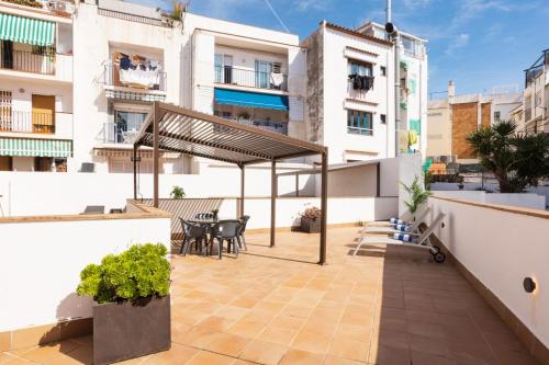 a balcony with a table and chairs on a building at Lucas House Apartments by Sitges Group in Sitges