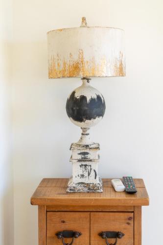 a lamp on a table with a remote control at Villa Serenity B&B in Sannat