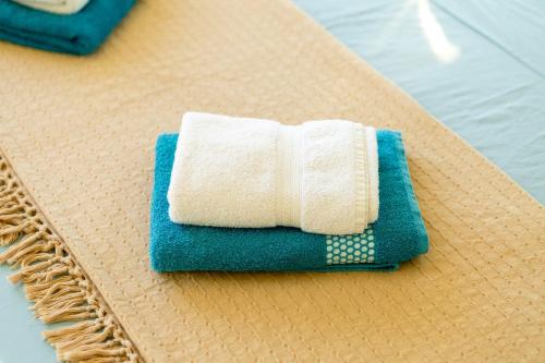 a white towel sitting on top of a placemat at Villa Serenity B&B in Sannat