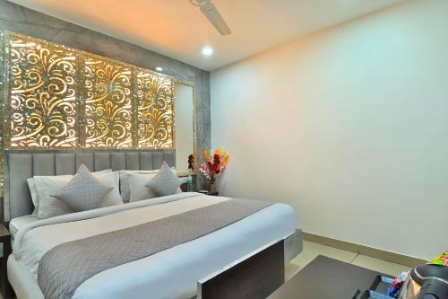 a bedroom with a large bed and a large window at The Bella Vista -Traveler's choice awarded in New Delhi